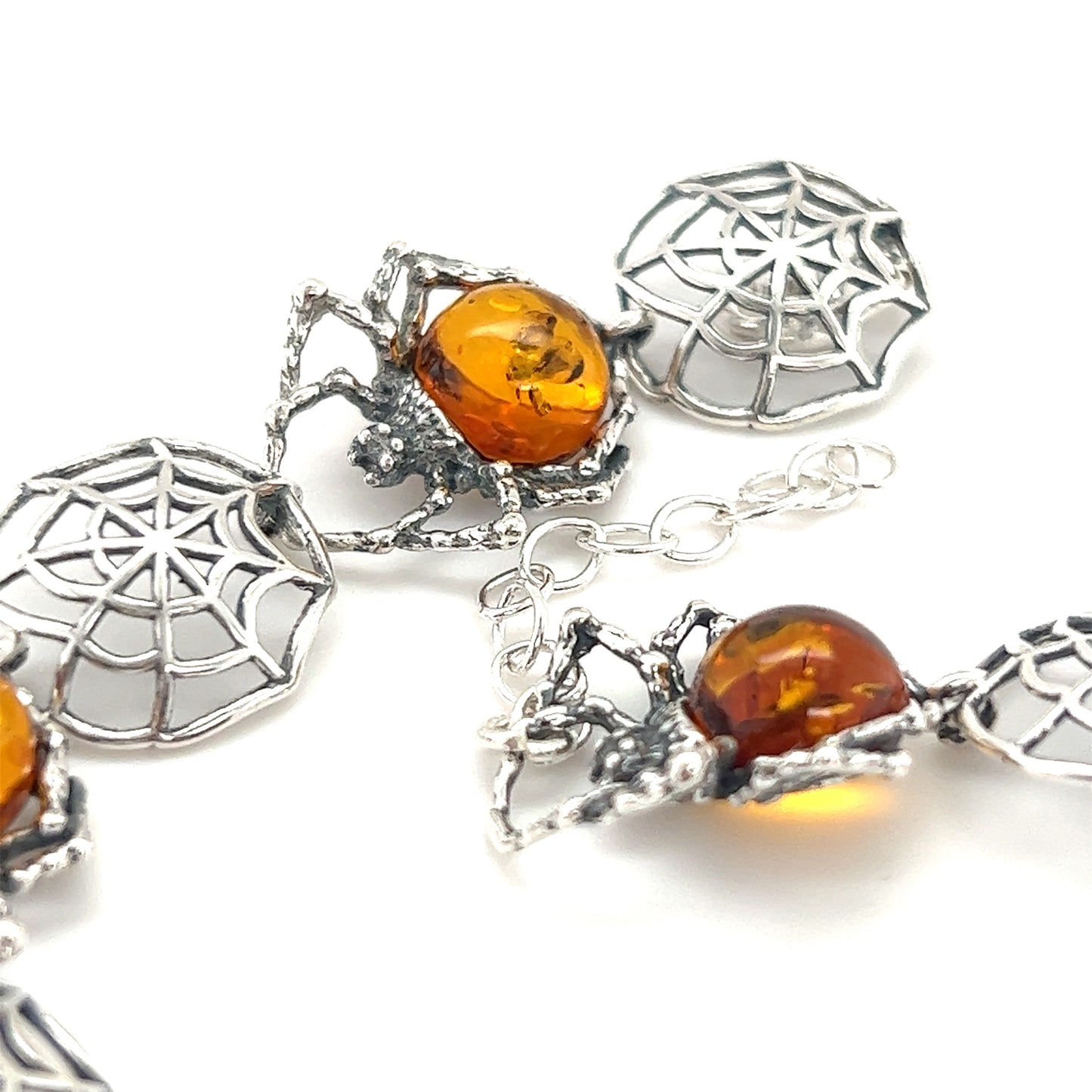 This Spellbinding Amber Spider Bracelet from Super Silver features intricate silverwork details and delicate amber beads, evoking the allure of a spider web.