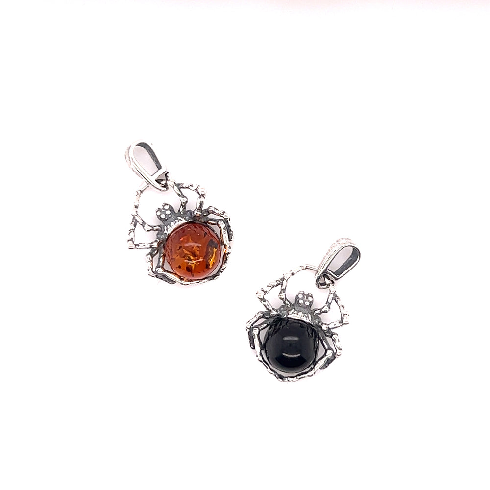 Two Delicate Baltic Amber Spider Pendants, exuding a witchy vibe. One pendant features a captivating amber stone while the other showcases an enchanting spider design from Super Silver.