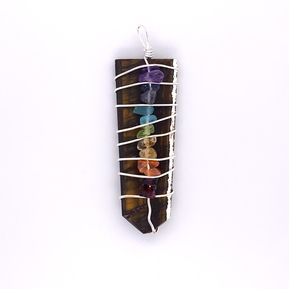
                  
                    A Stone Slab Wire-Wrapped Chakra Pendant adorned with colorful gemstones.
                  
                
