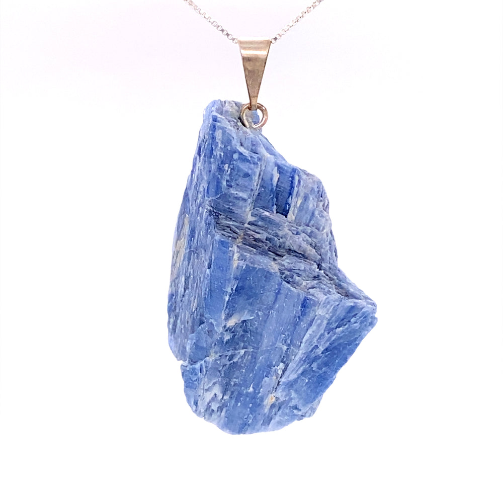 
                  
                    A Raw Crystal Pendant decorated with a blue sapphire, hanging gracefully from a chain.
                  
                
