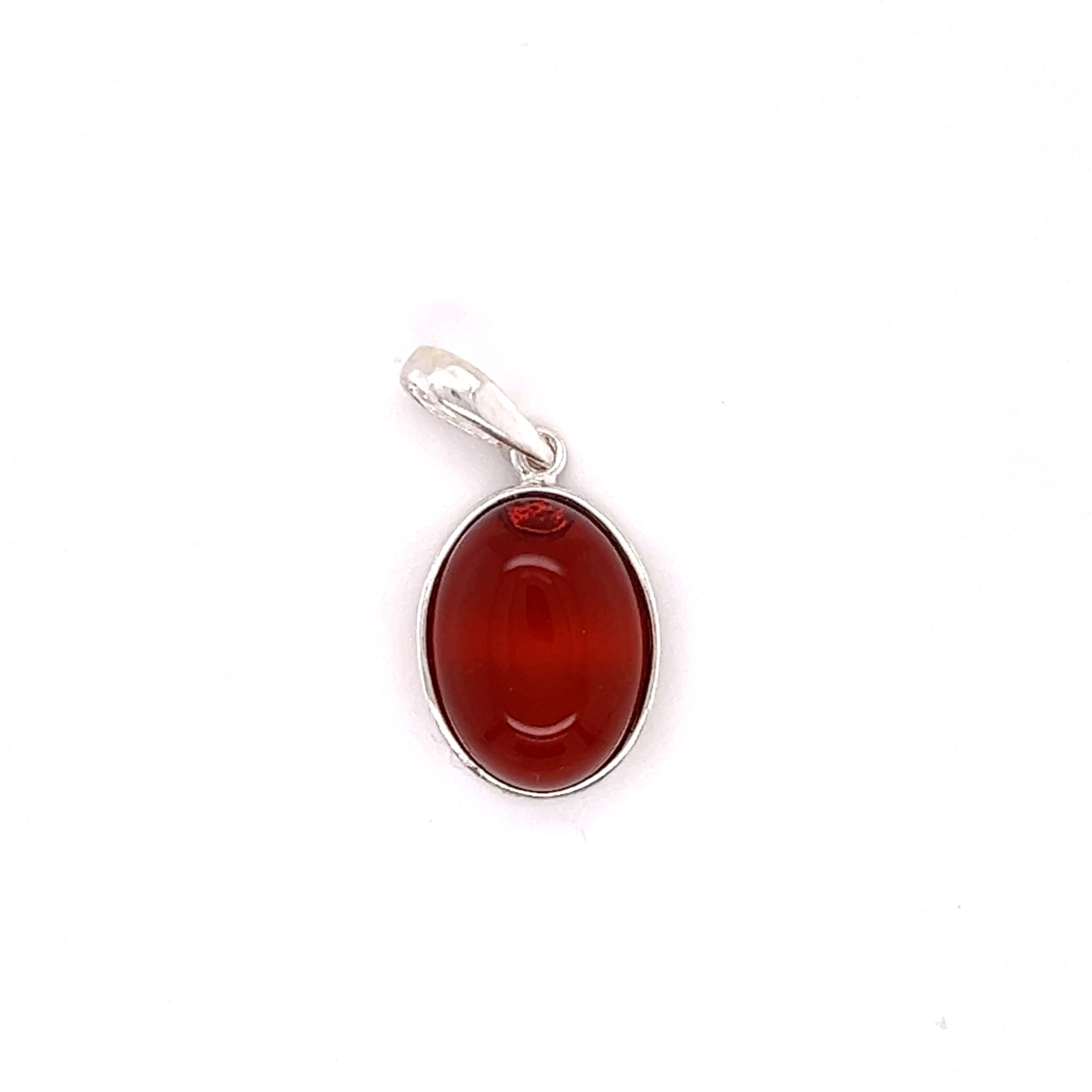 A Timeless Oval Amber Pendant by Super Silver with a red stone showcasing healing properties.