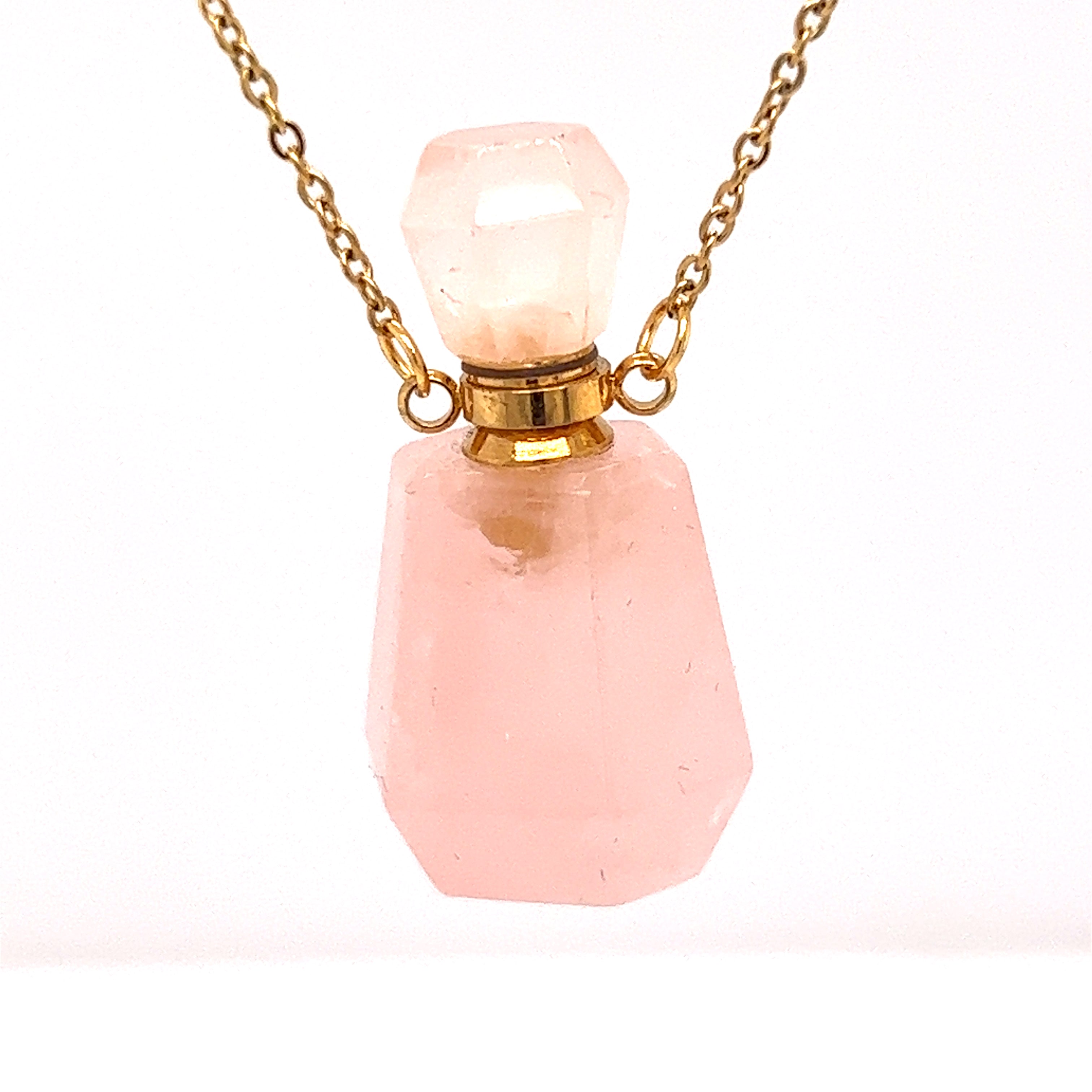 A Crystal Perfume Vial Necklace on a gold chain, featuring a pink quartz stone by Super Silver.