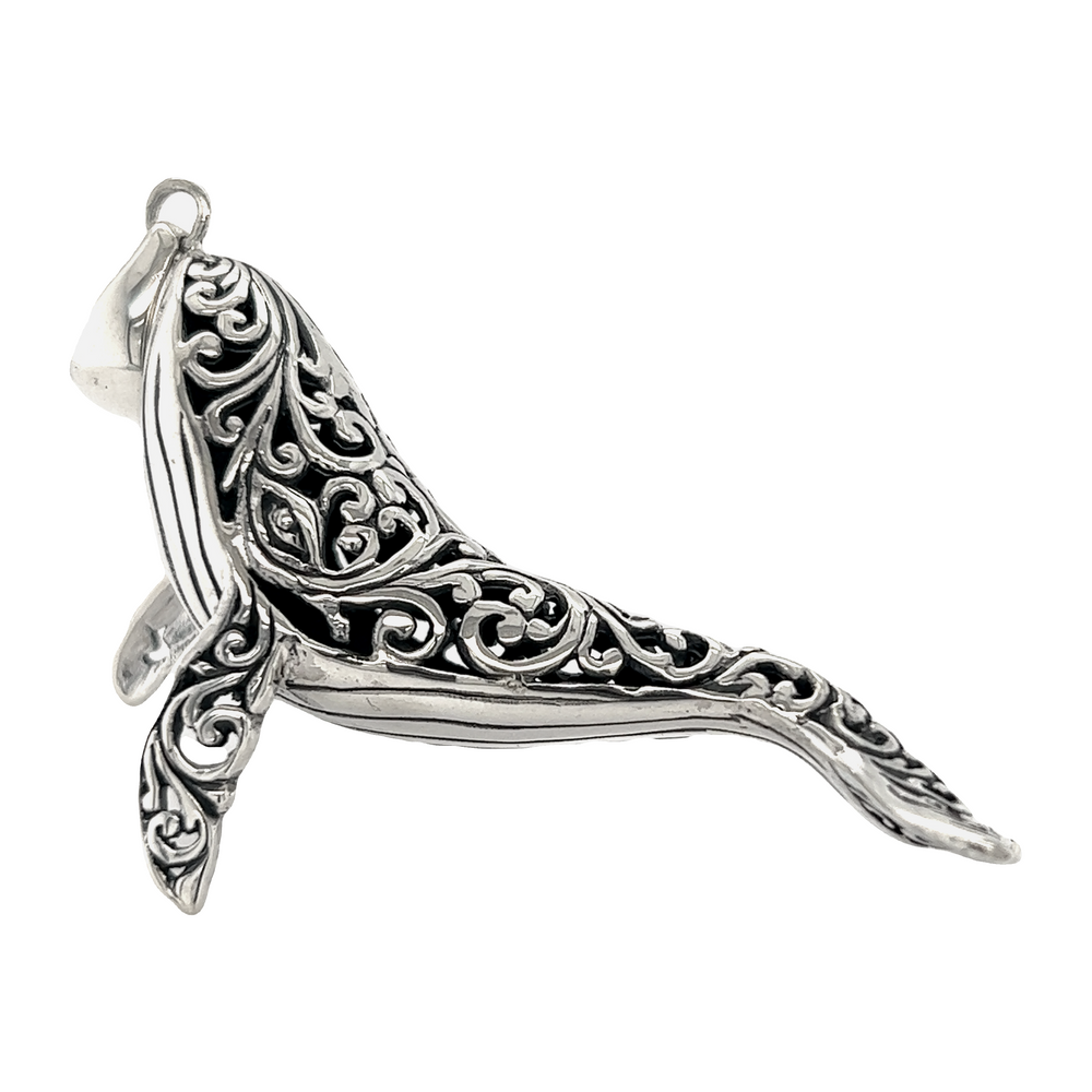 A Super Silver Magnificent Filigree Whale Pendant with an intricate design inspired by the ocean.