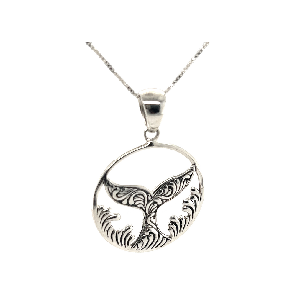 A Dazzling Circular Whale Tail Pendant with a whale tail, reminiscent of the ocean in Santa Cruz by Super Silver.