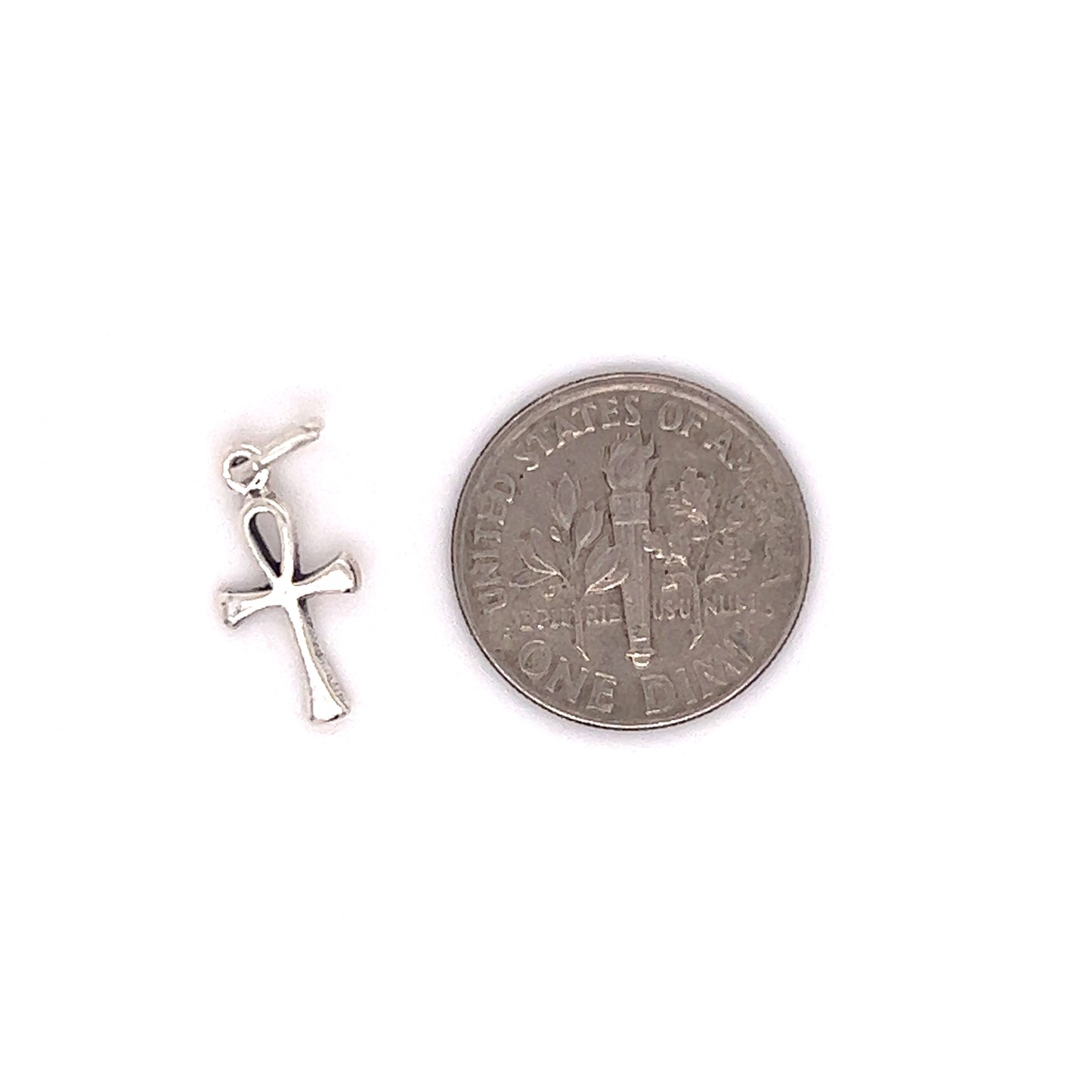 An Egyptian symbol of eternal life, the Enchanting Tiny Ankh Charm by Super Silver, is placed next to a silver coin.