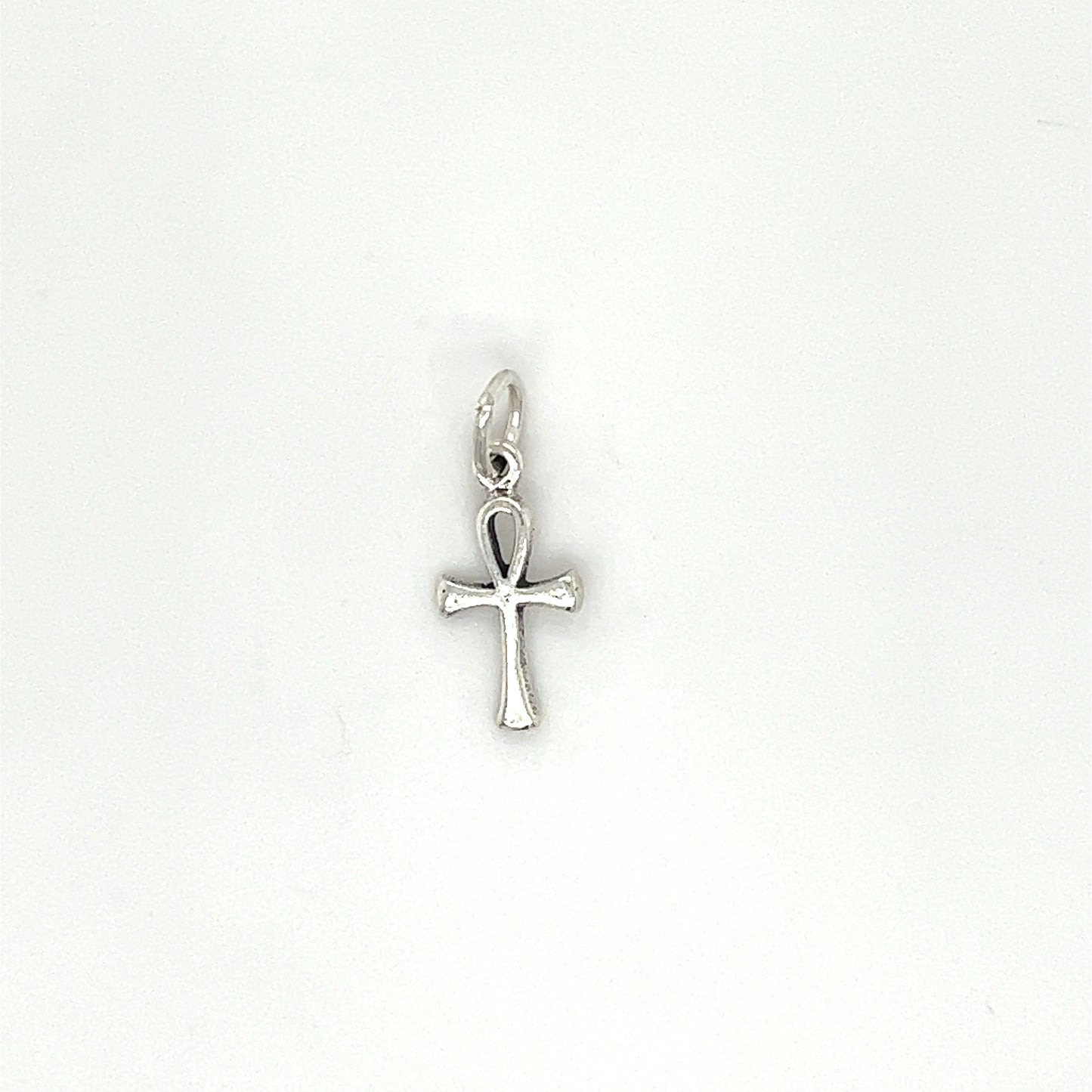 A small silver Enchanting Tiny Ankh Charm representing eternal life on a white background by Super Silver.