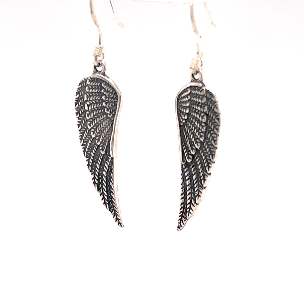
                  
                    A pair of Super Silver Charming Wing Earrings on a white background.
                  
                