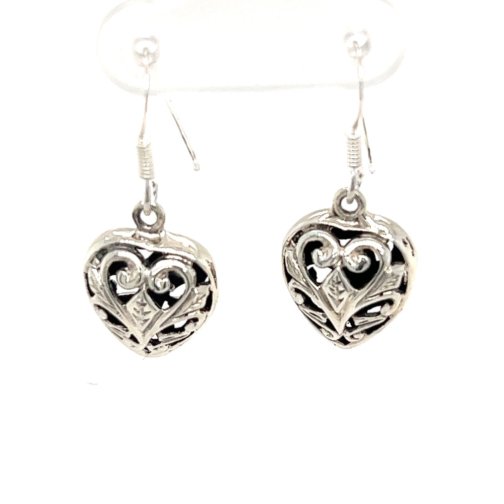 A pair of Super Silver Timeless Filigree Heart Earrings on a white background.