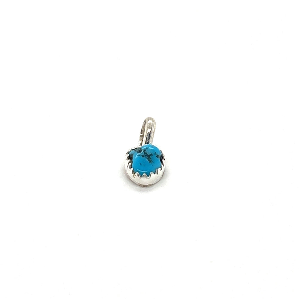 
                  
                    A Teeny Tiny Native American Turquoise Nugget Pendant featuring a sterling silver charm with a turquoise stone in a silver claw tooth frame made by Super Silver.
                  
                