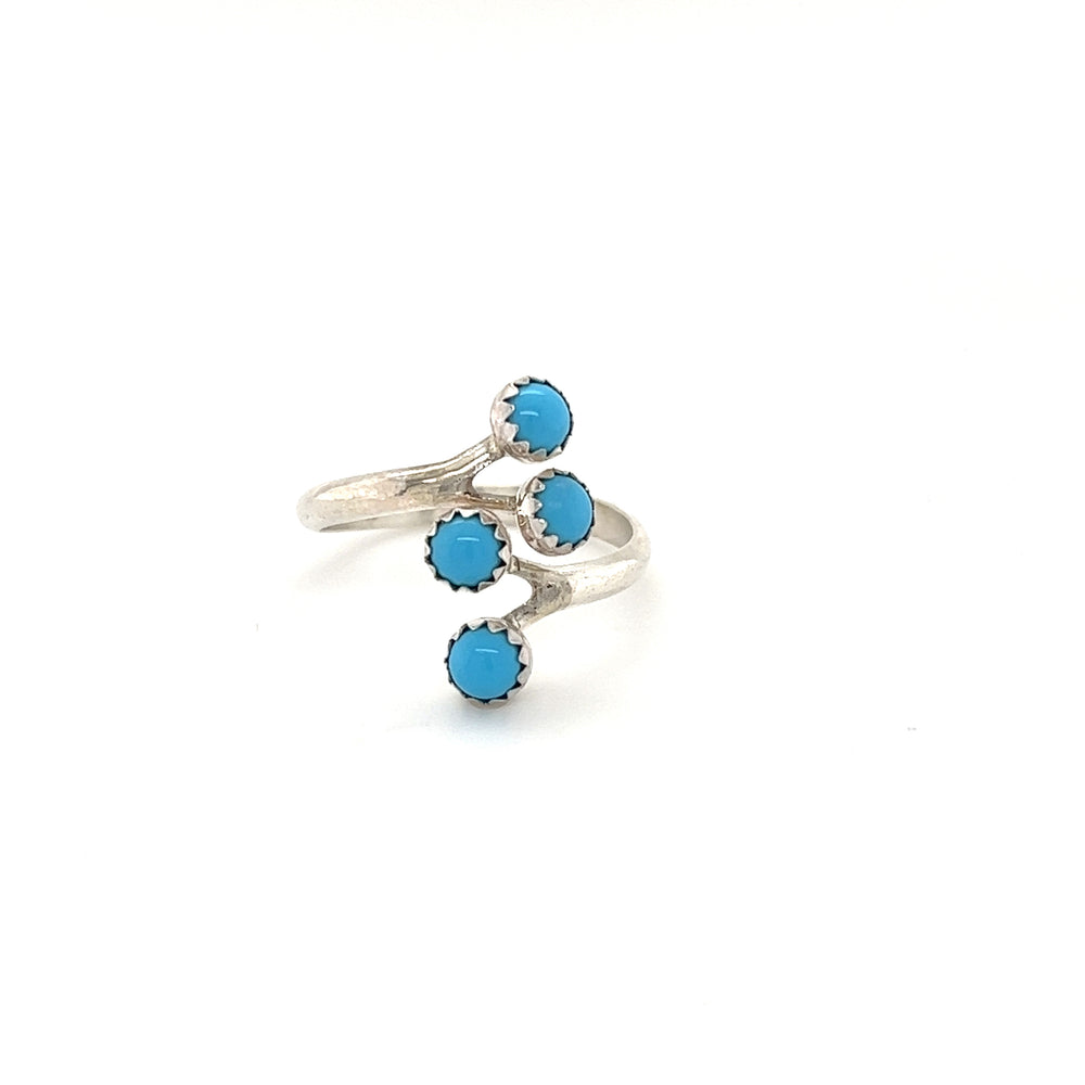 A cultural Handmade Turquoise Wrap ring adorned with three turquoise stones.