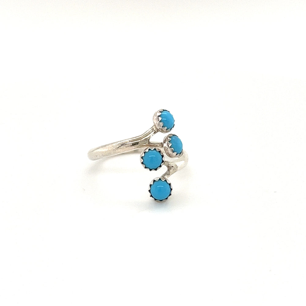 A Handmade Turquoise Wrap Ring with three turquoise stones on a white background.