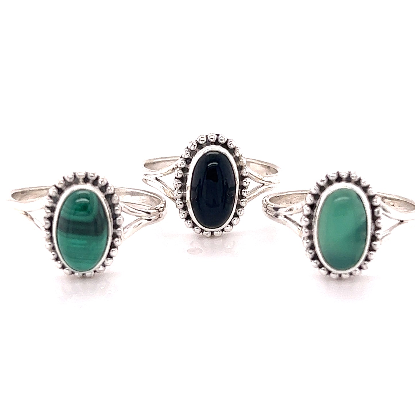 
                  
                    Three Stylish Oval Gemstone Rings with Ball Border in green and black hues from Santa Cruz.
                  
                