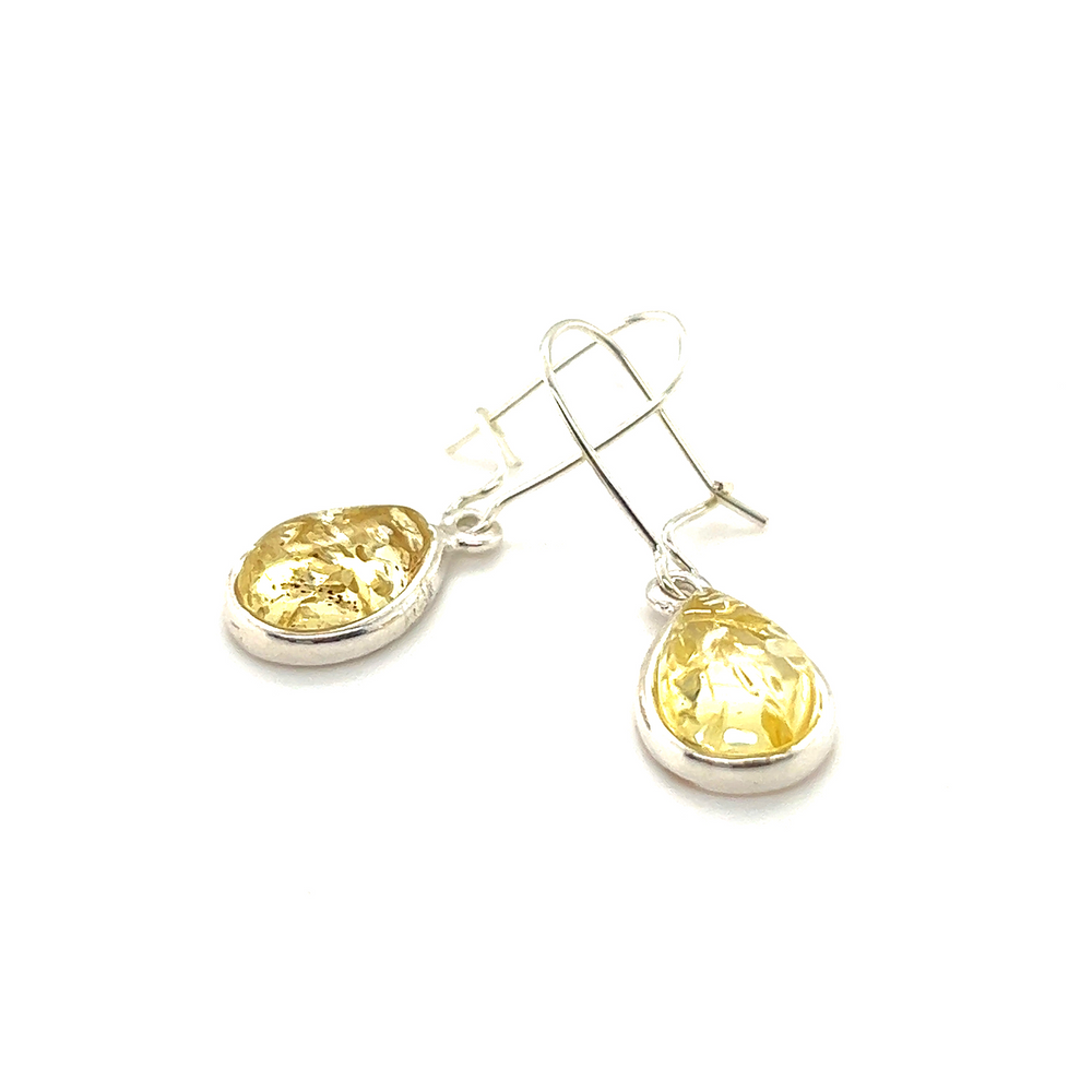 
                  
                    A pair of Charming Baltic Amber Teardrop Earrings with a sparkling yellow citrine by Super Silver.
                  
                