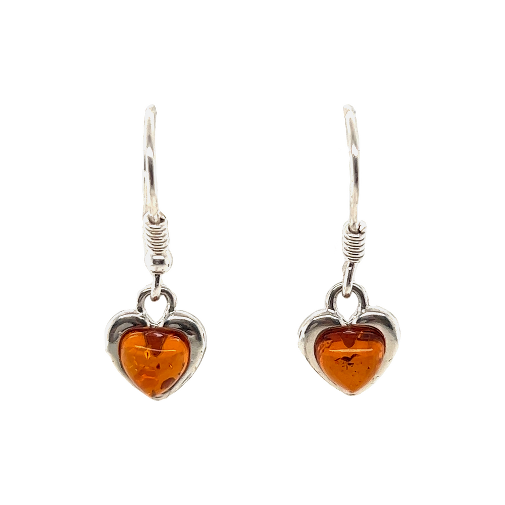 A pair of Dainty Amber Heart Earrings crafted with sterling silver, known for their soothing properties, from the brand Super Silver.