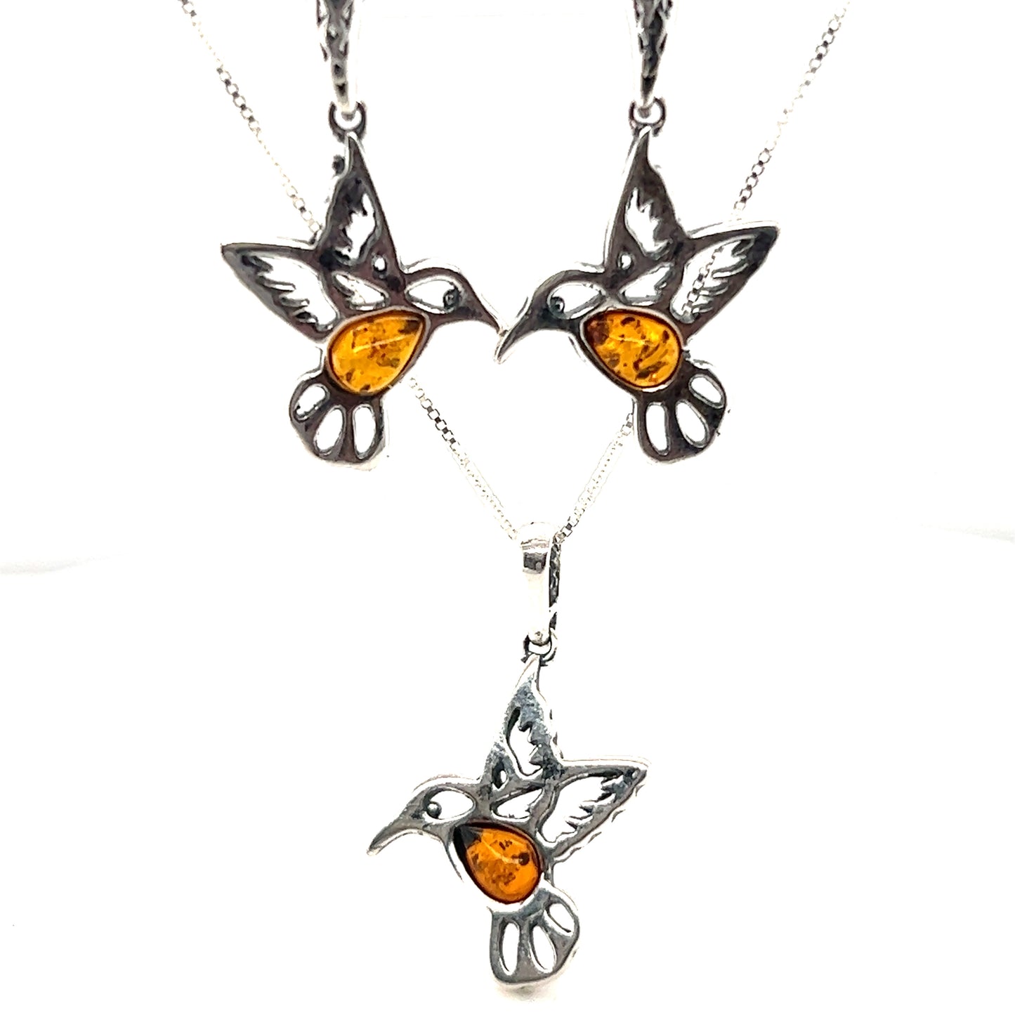 
                  
                    A Super Silver Amber Hummingbird pendant and earrings set adorned with amber accents.
                  
                