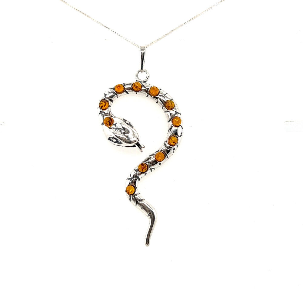 A mesmerizing Large Amber Snake pendant adorned with deep cognac amber crystals on a sleek Super Silver chain.