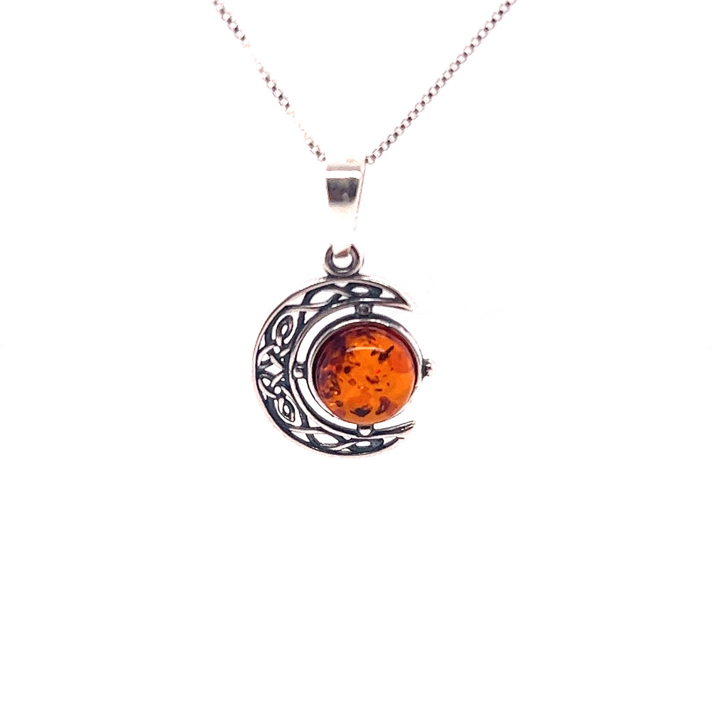 A Celtic Amber Crescent Moon Pendant from Super Silver with a crescent moon on it.