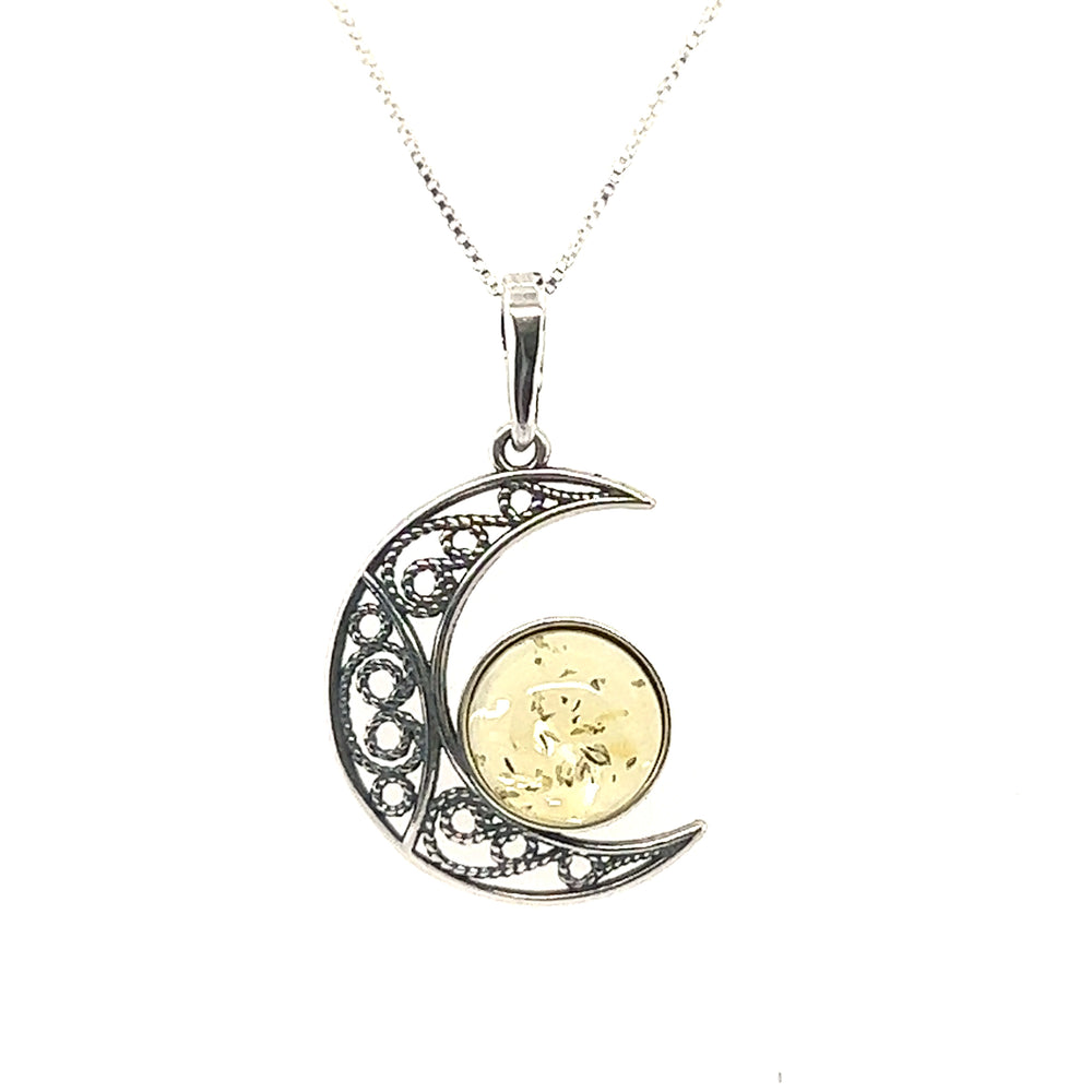A Stunning Filigree Amber Moon Pendant with a crescent moon and an amber stone by Super Silver.