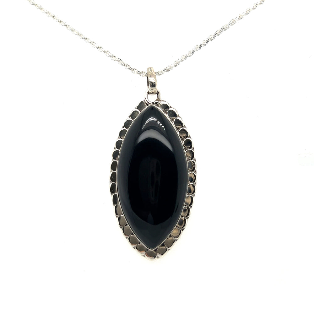 
                  
                    A powerful Statement Onyx Pendant With a Textured Setting by Super Silver on a silver chain.
                  
                