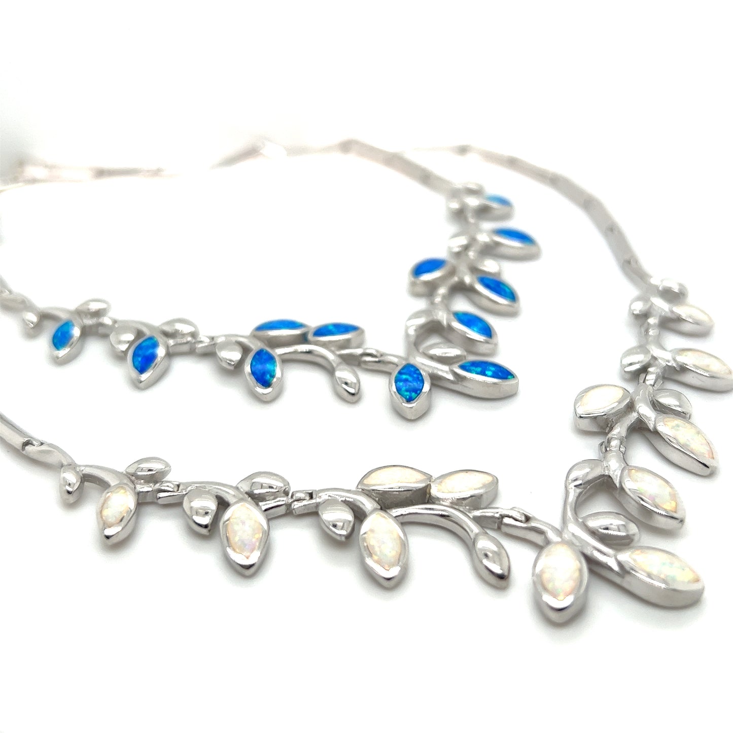 
                  
                    A Super Silver Elegant Opal Vine Necklace adorned with delicate blue opal stones and leaves.
                  
                