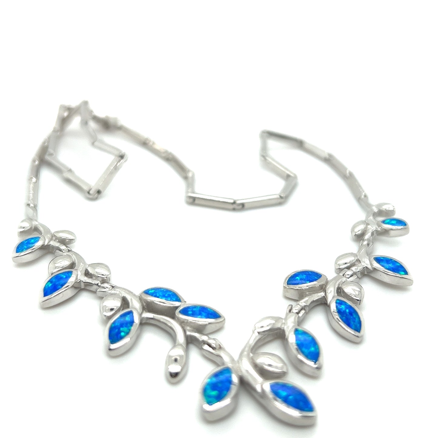 
                  
                    A Super Silver Elegant Opal Vine Necklace adorned with blue opal leaves, making it a stunning statement piece.
                  
                
