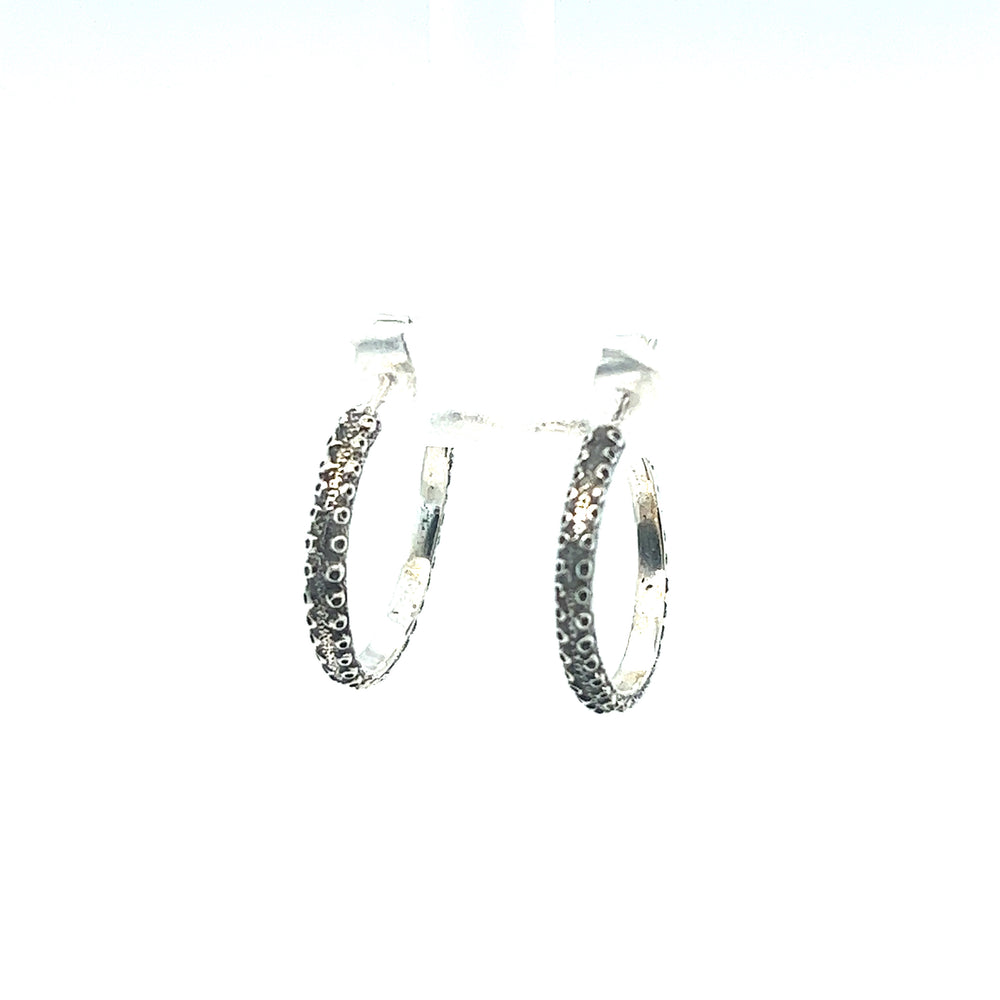 A pair of Handcrafted Octopus Tentacle Hoop earrings with black diamonds, featuring an oxidized finish, by Super Silver.