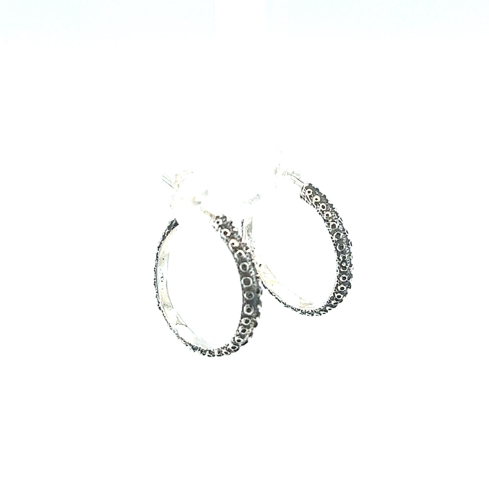 
                  
                    A pair of Handcrafted Octopus Tentacle Hoops by Super Silver with black diamonds and an oxidized finish.
                  
                