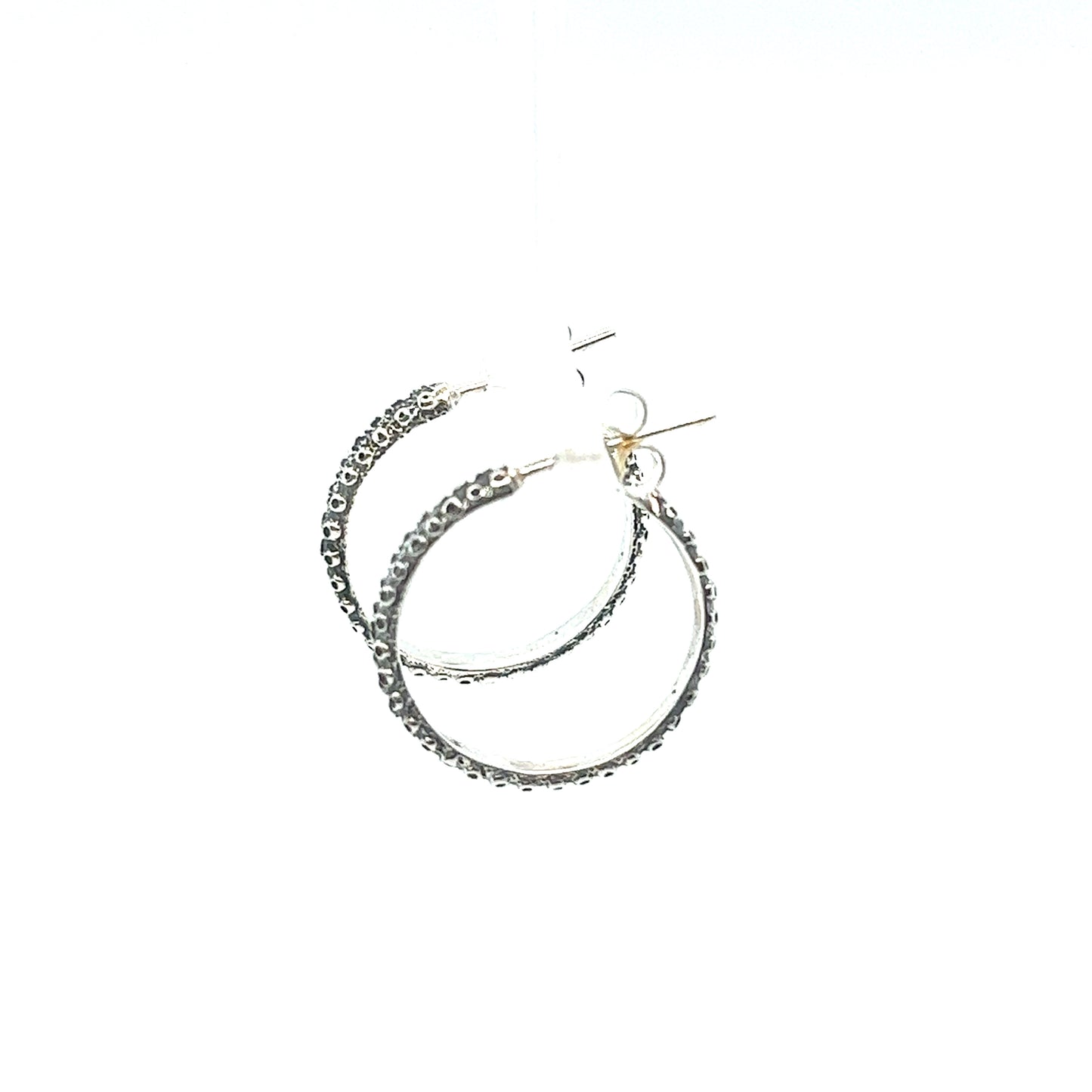 
                  
                    A pair of Super Silver Handcrafted Octopus Tentacle Hoops with an oxidized finish on a white background.
                  
                