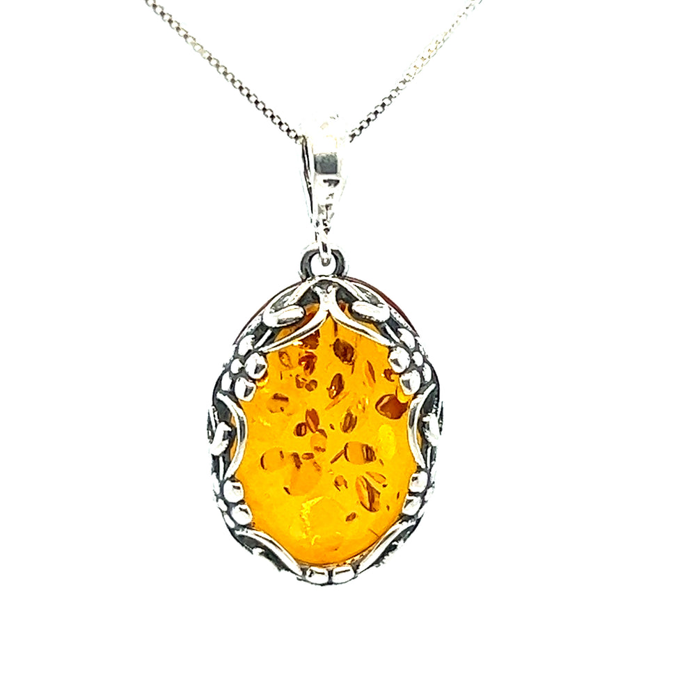 
                  
                    Cognac Amber Oval Pendant with Floral Border by Super Silver.
                  
                