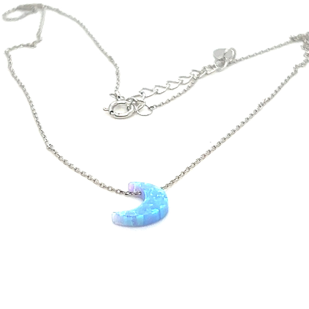 
                  
                    A Super Silver Blue Opal Moon Necklace with a blue moon on it.
                  
                