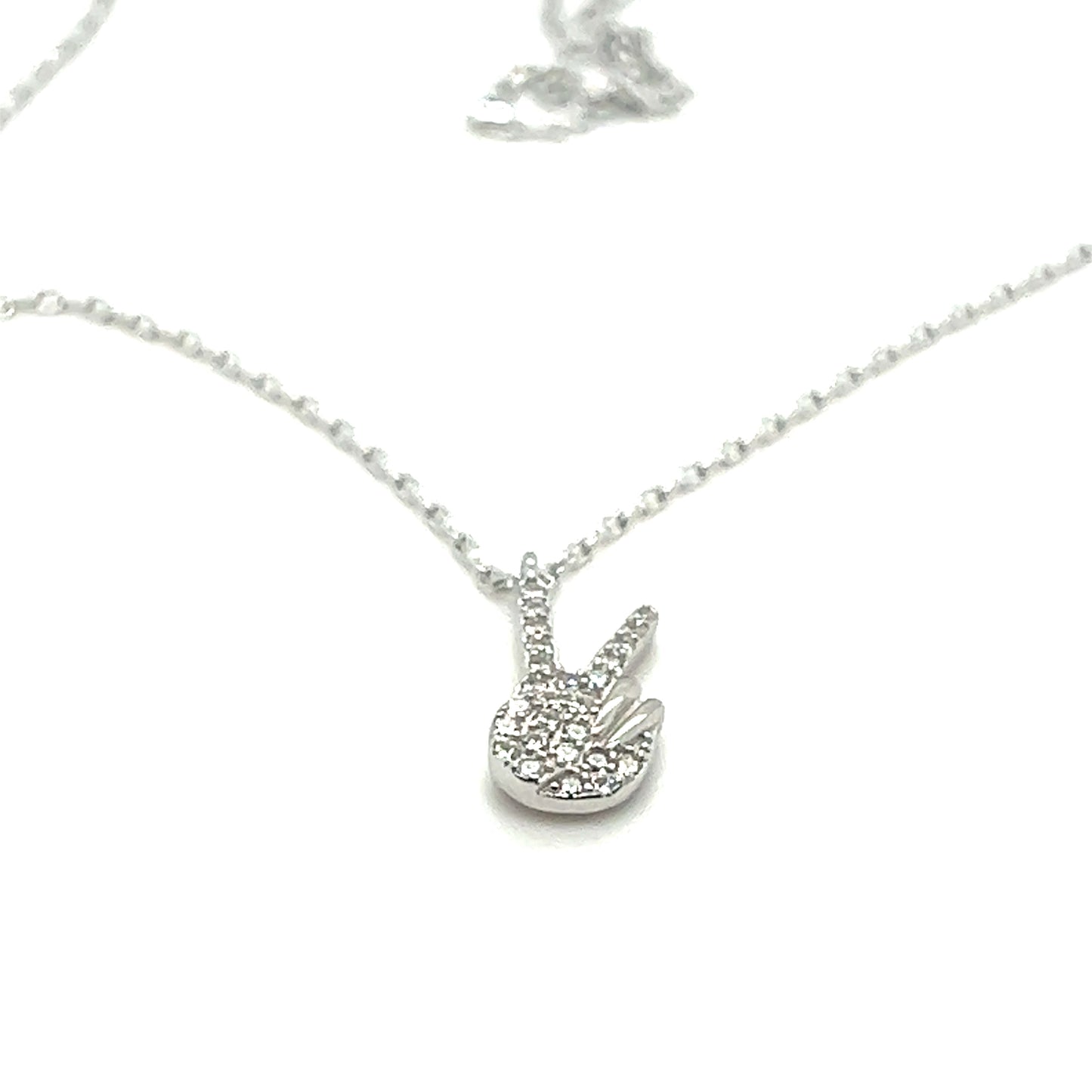 A Glitzy Peace Sign Necklace with a diamond pendant on it. Super Silver jewelry.