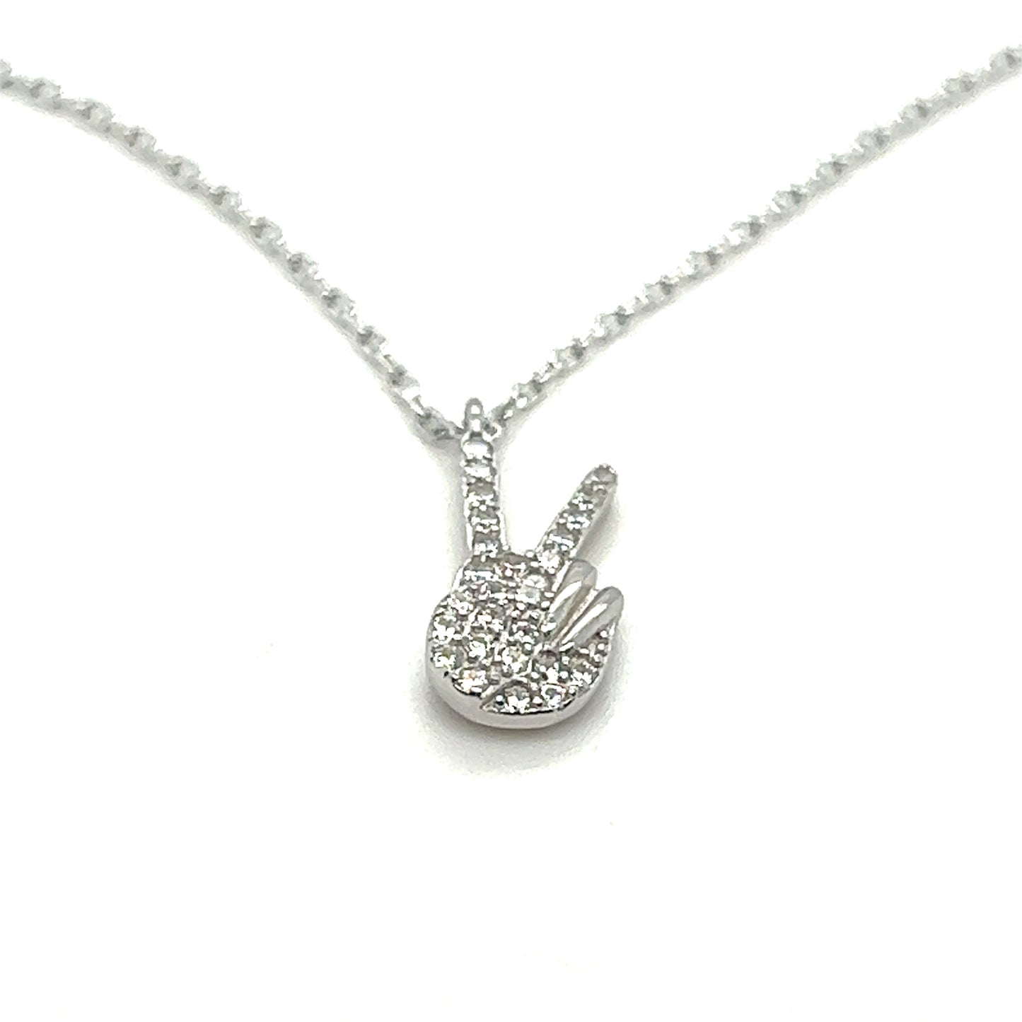 A Glitzy Peace Sign Necklace with a diamond hand on it from Super Silver.