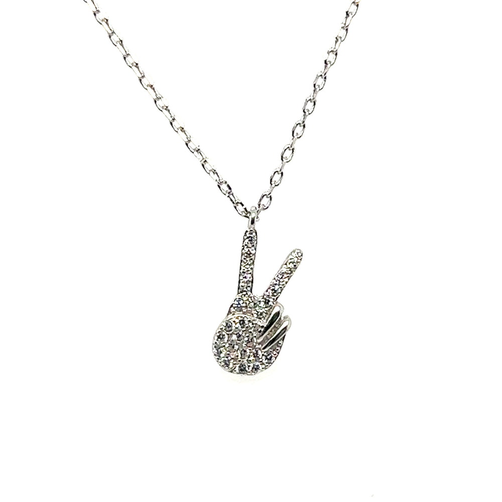 
                  
                    A Glitzy Peace Sign Necklace by Super Silver, featuring a diamond peace sign on it.
                  
                