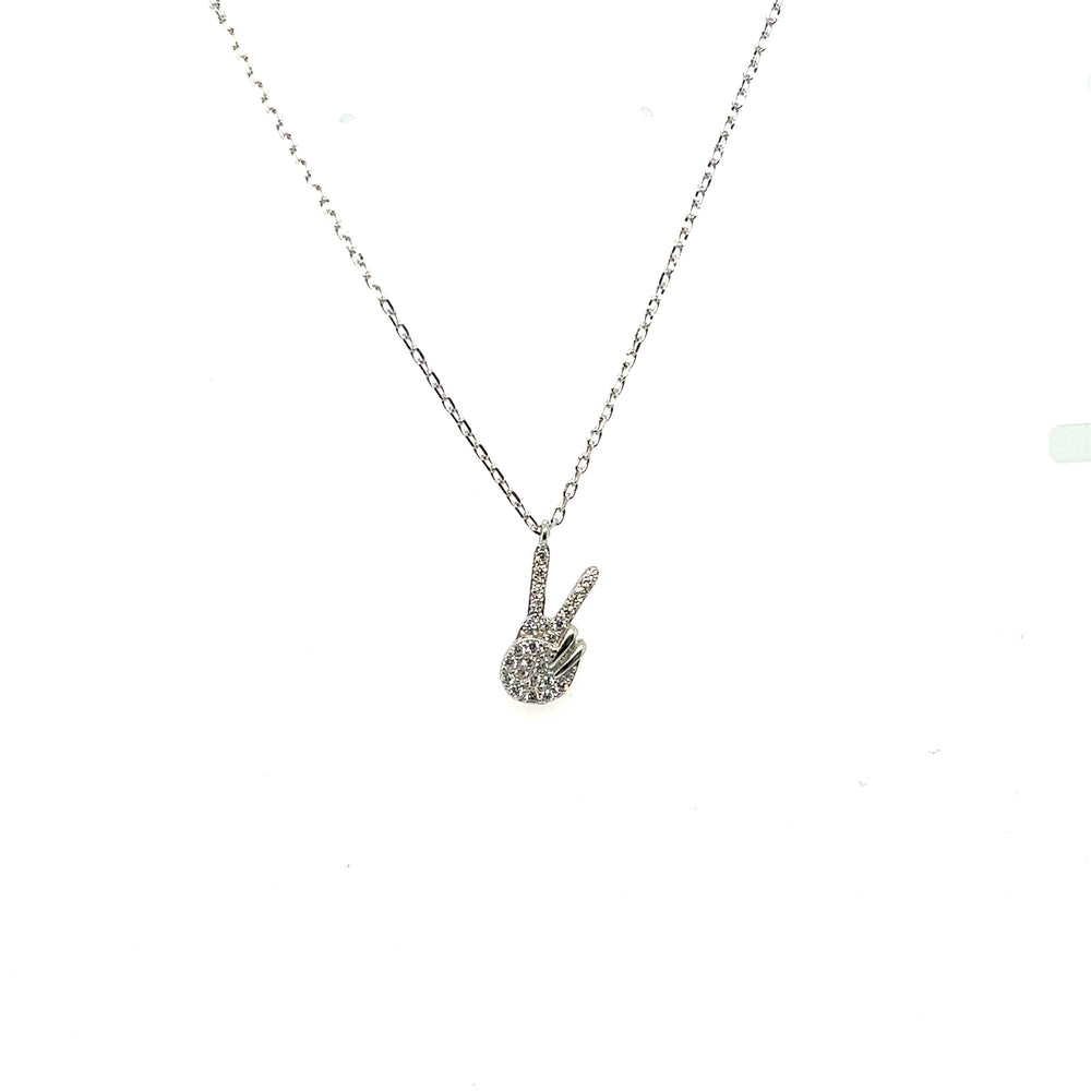 
                  
                    A Glitzy Peace Sign Necklace adorned with a diamond peace sign from Super Silver.
                  
                