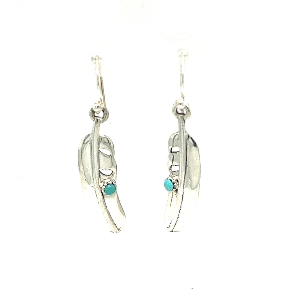 
                  
                    A pair of Super Silver High Shine Feather Earrings with Turquoise stones, perfect for adding boho charm to any outfit.
                  
                