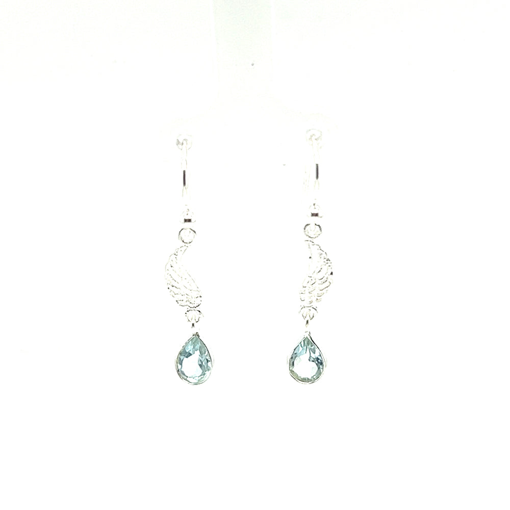 A pair of Super Silver Angel Wing Earrings with Teardrop Shaped Stone, featuring blue topaz stones, on a white background.