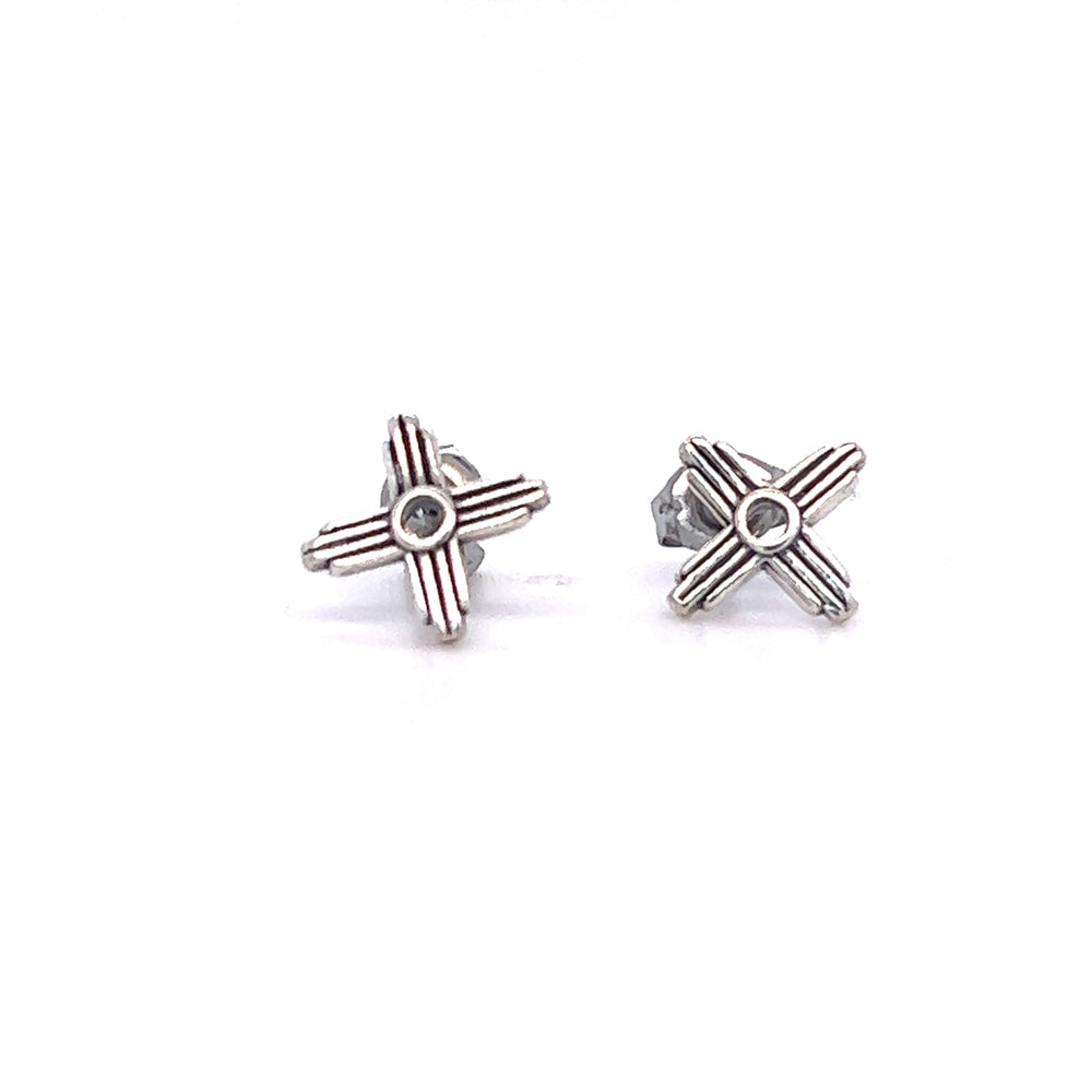 A pair of Super Silver Zia Sun Studs with red and white Zia sun symbolism designs.