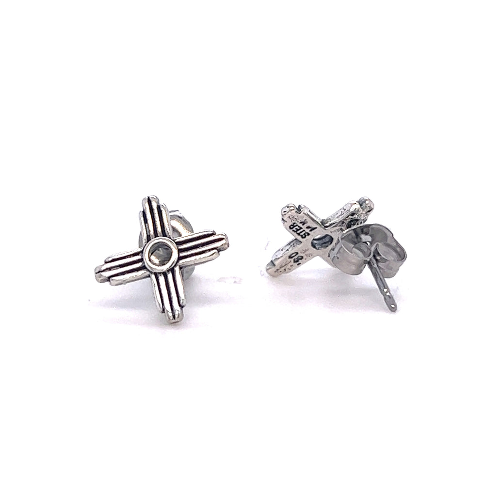 
                  
                    A pair of Super Silver Zia Sun Studs with a cross design, adding symbolism to the simplistic elegance.
                  
                