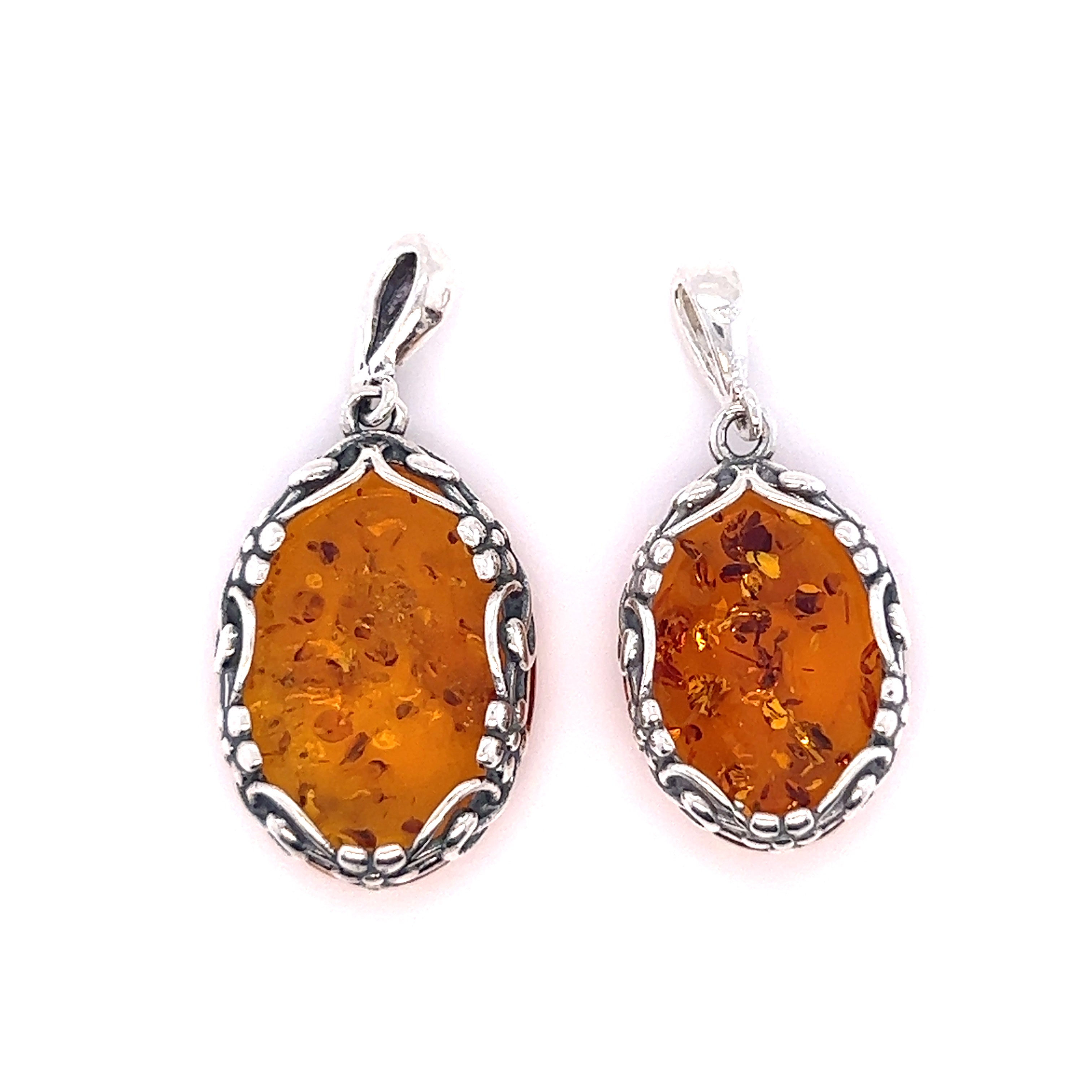 A pair of Super Silver Cognac Amber Oval Pendants with Floral Border on a white background.