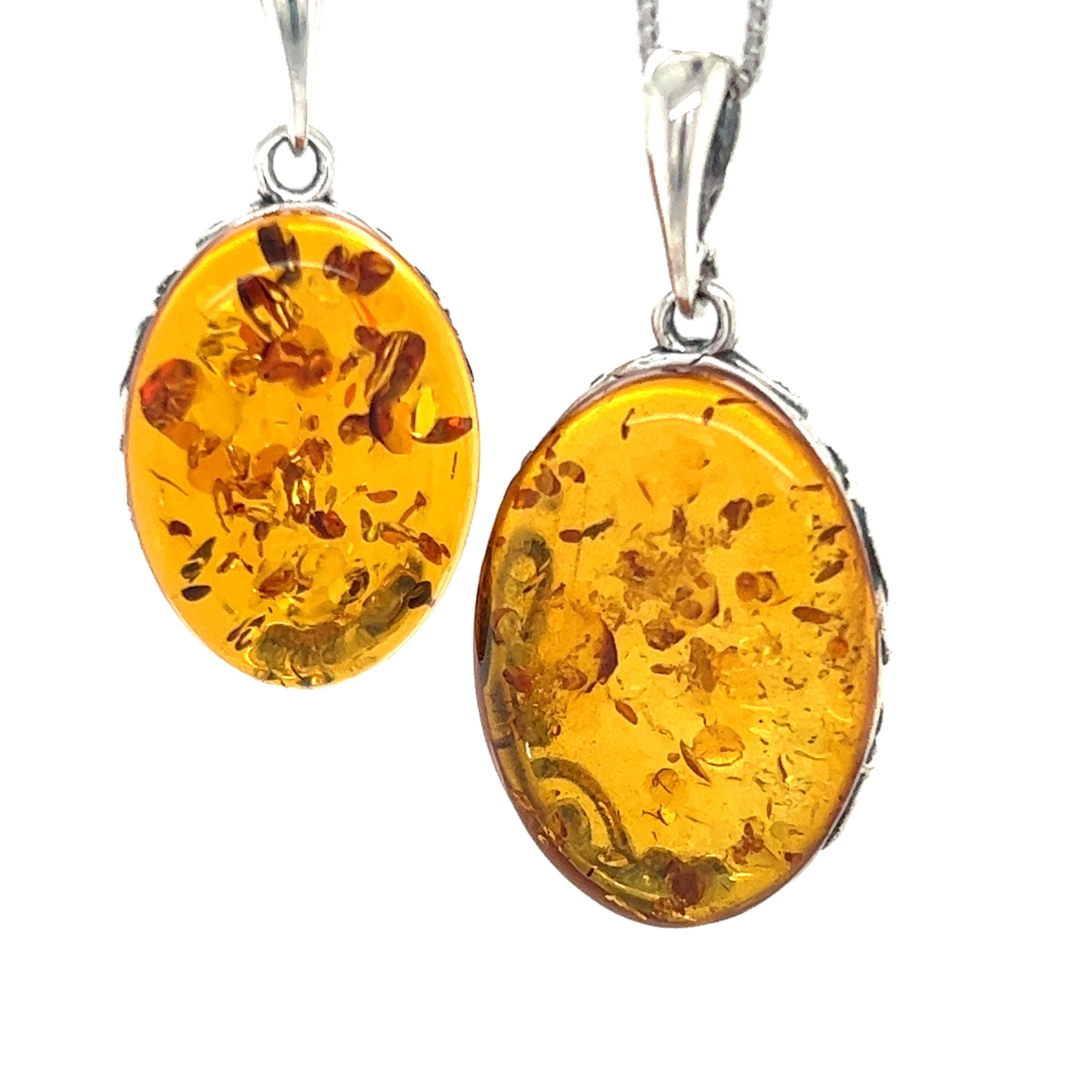 Two Cognac Amber Oval Pendants with Floral Border on a Super Silver chain.