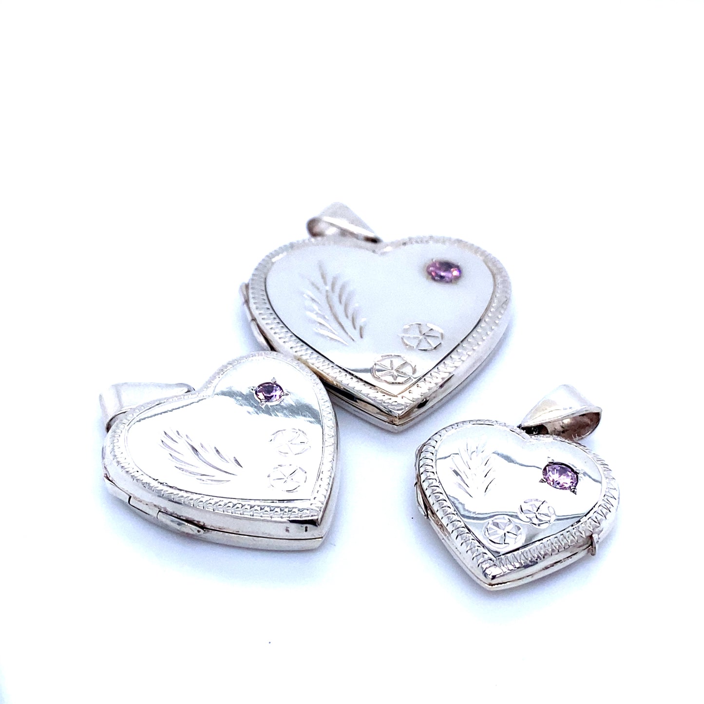 
                  
                    Three Heart Shaped Lockets with Stone and lacy Etching.
                  
                