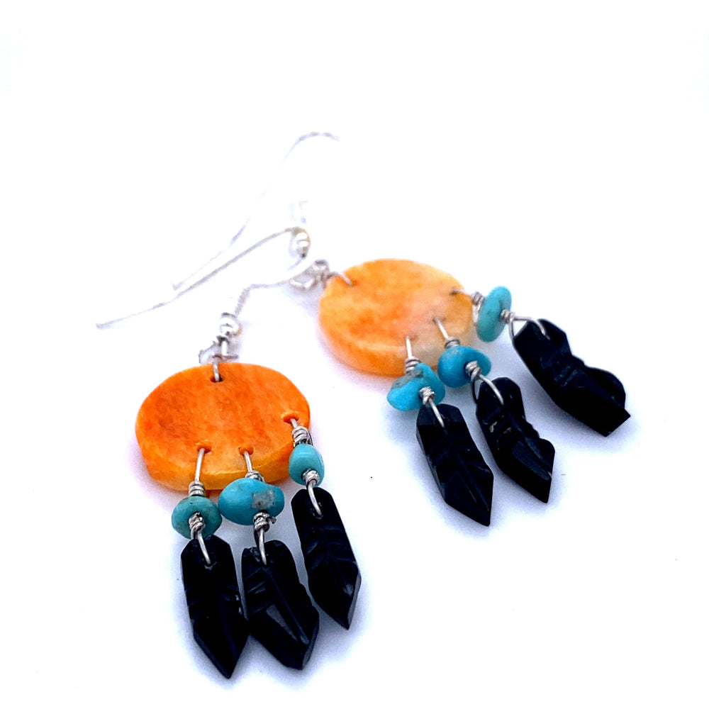 
                  
                    A pair of Handmade Earrings with 3 Small Stone Feathers crafted by Native American artisans, featuring turquoise and orange beads, produced by Super Silver.
                  
                
