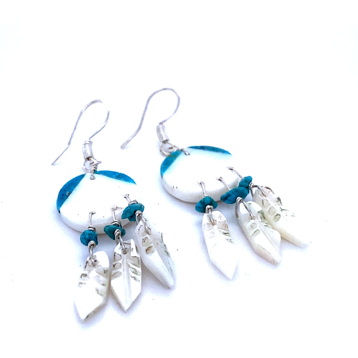 
                  
                    A pair of Handmade Earrings with 3 Small Stone Feathers inspired by Native American culture, made by Super Silver.
                  
                
