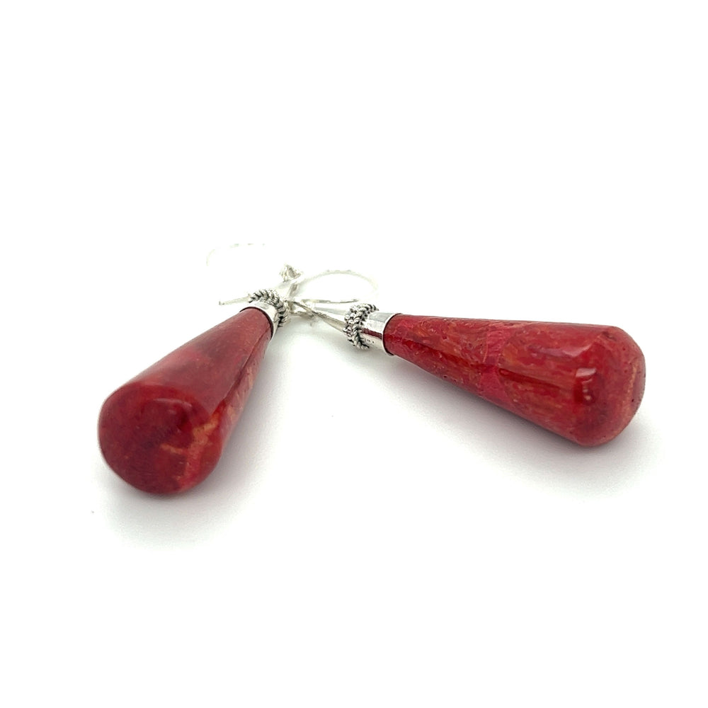 A pair of Super Silver Long Sponge Coral Drop Earrings on a white background, symbolizing happiness.
