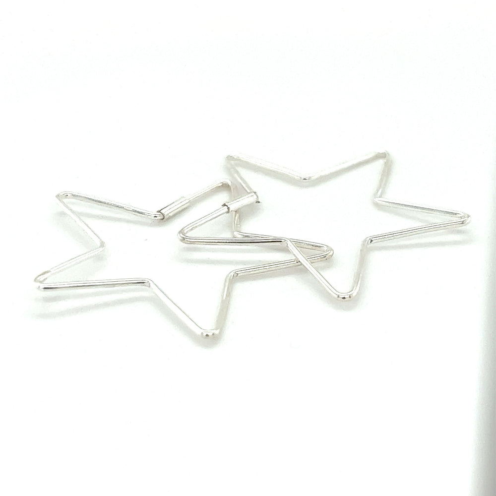 
                  
                    Two Delicate Star Shaped Hoops from Super Silver on a white surface.
                  
                