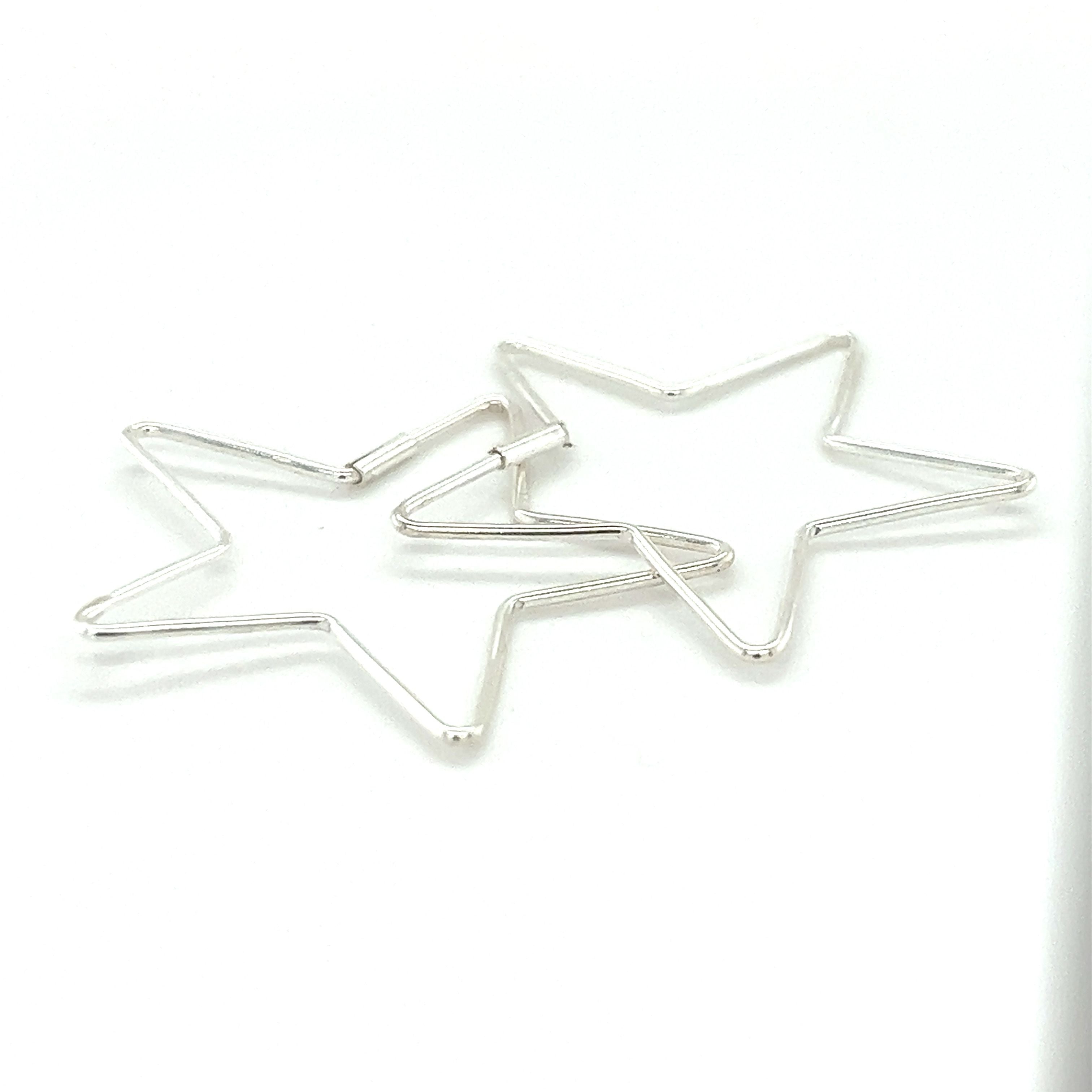 Two Delicate Star Shaped Hoops from Super Silver on a white surface.