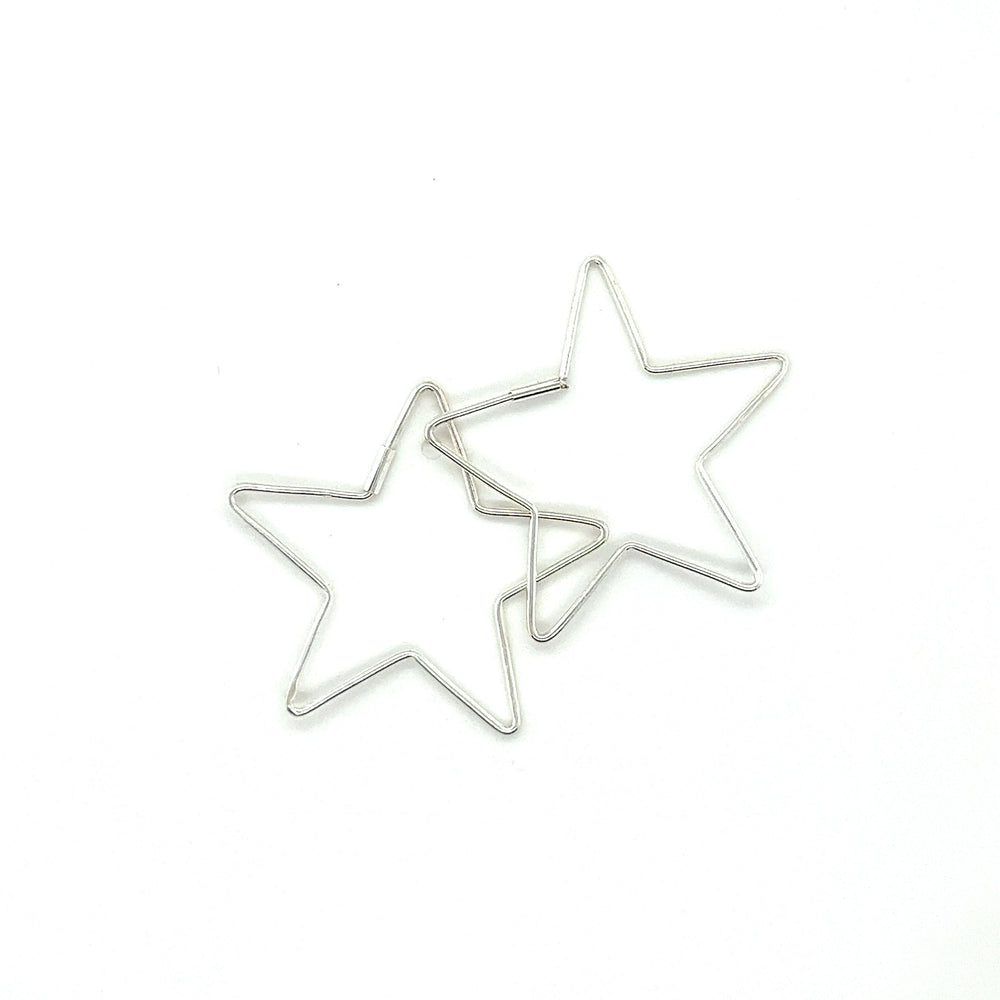 
                  
                    Two Delicate Star Shaped Hoops by Super Silver on a white surface.
                  
                