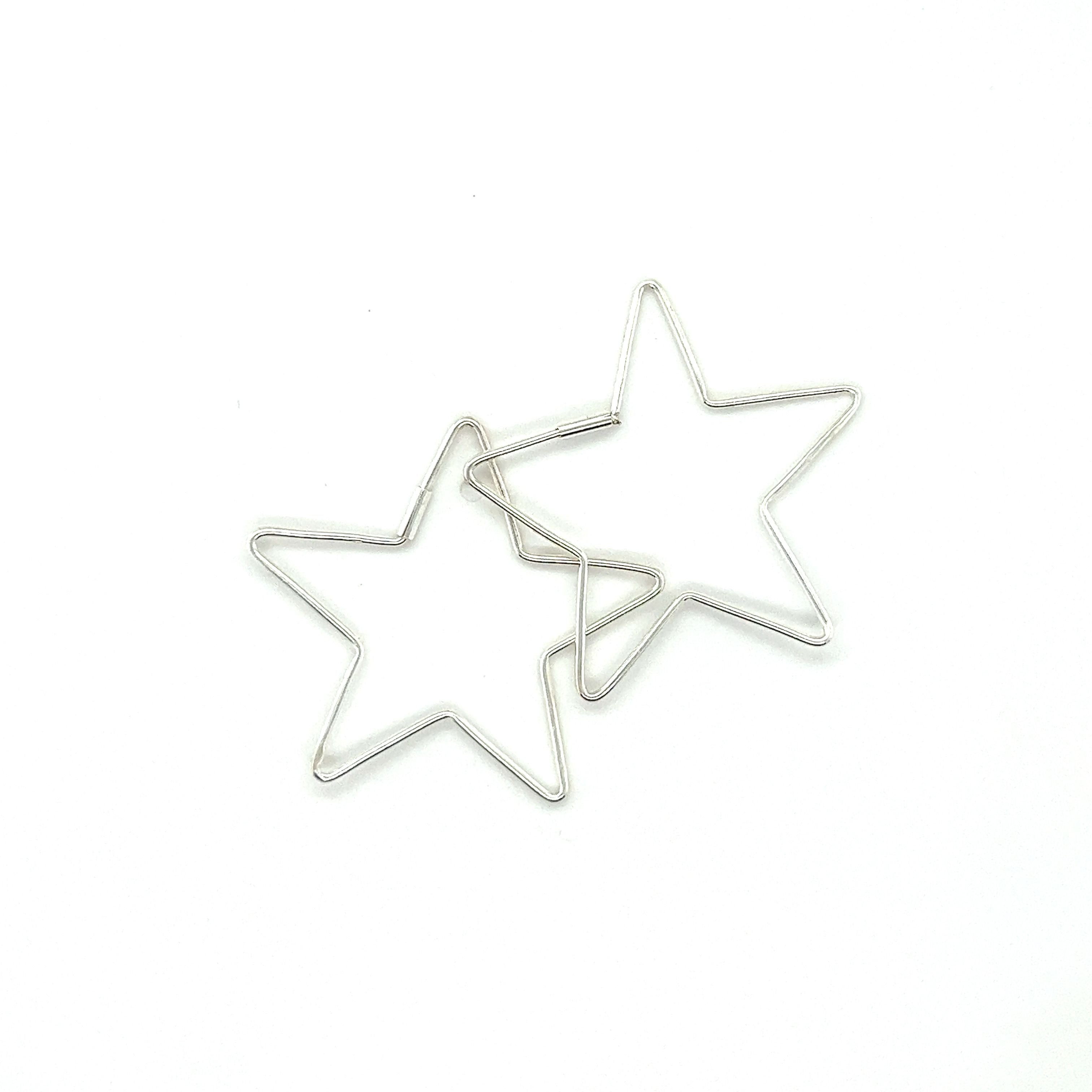 Two Delicate Star Shaped Hoops by Super Silver on a white surface.