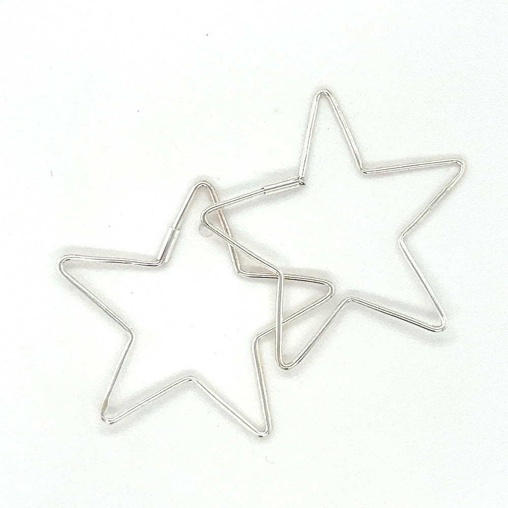 
                  
                    Two Delicate Star Shaped Hoops earrings by Super Silver on a white surface.
                  
                