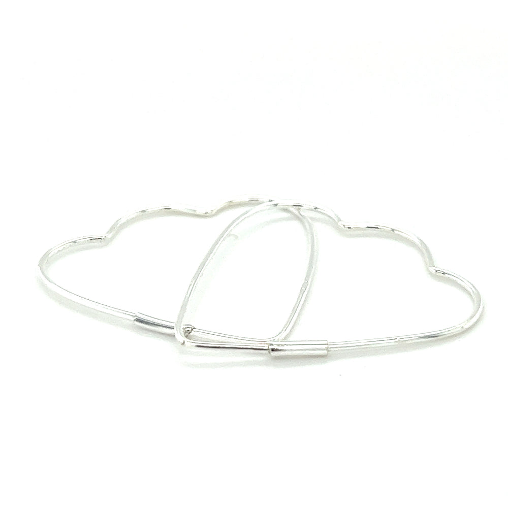 
                  
                    A pair of Delicate Heart Shaped Hoops by Super Silver on a white surface.
                  
                